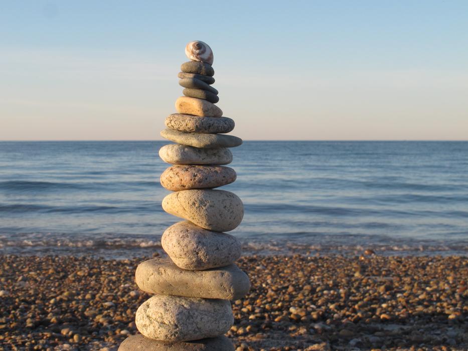 a large tower of stones in the sea