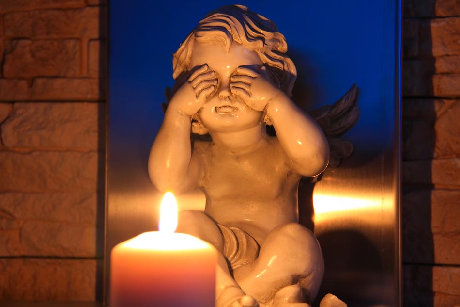 a sleeping angel by a candle