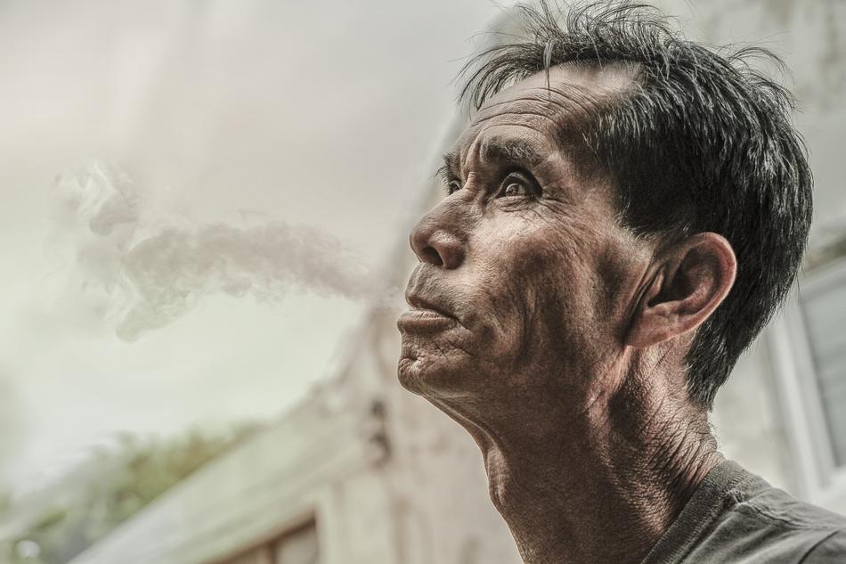 man spits water