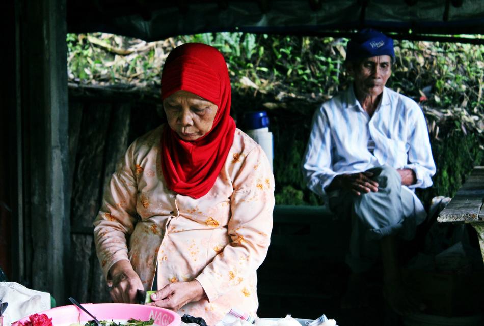 old woman cooks a meal