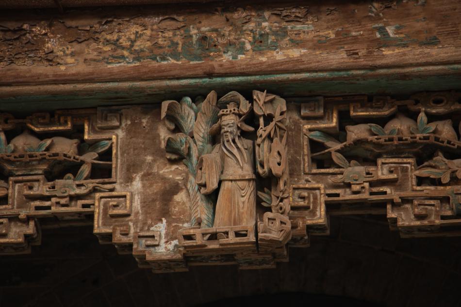 wooden carved figure on the ceiling