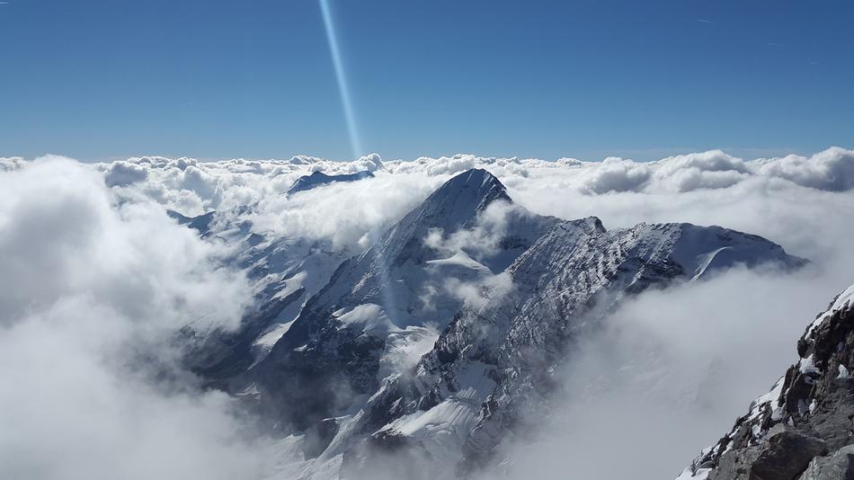 sun rays on top of monte zebru, Italy