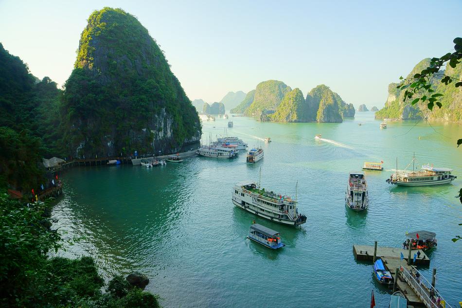 green mountains with boats on the lake
