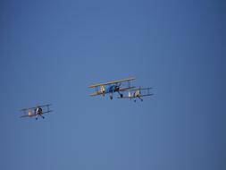 Three flying planes at blue sky background