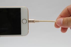 hand holding the charger on the phone