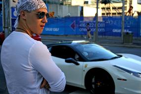 a man in a white bandana by the car