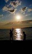 Landscape of Children on beach at sunset