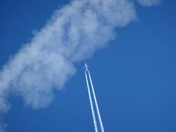 a white cloud against a blue sky landscape