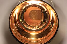 Close-up of the colorful, shiny photomultiplier tube, in the light