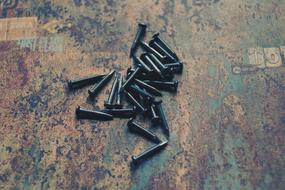 spilled nails on a metal surface