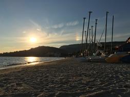 Sailing Boats on Beach at Sunset