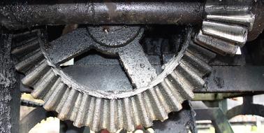 Close-up of the shiny, metal gears in the construction