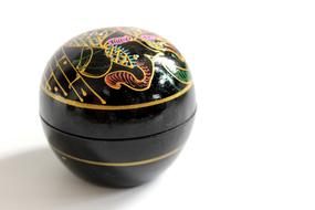 Close-up of the beautiful, shiny, black decoration with the colorful painting