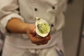 Mussels with stuffing in hand