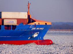 winter photo of a cargo ship on the Elbe river