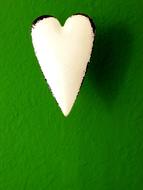 a white heart on a green background