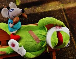 plush mouse on a toy green frog