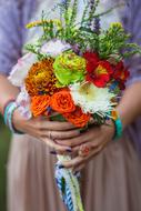 colored bouquet in hand