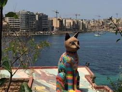 multi-colored cat statue on the shore in Malta