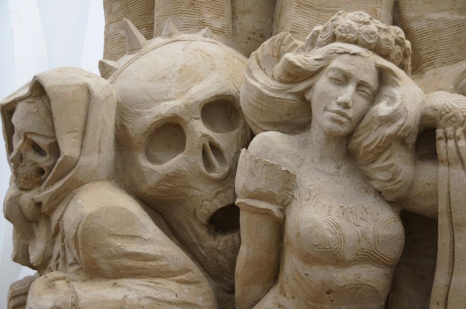 An old sculpture of a girl and skulls