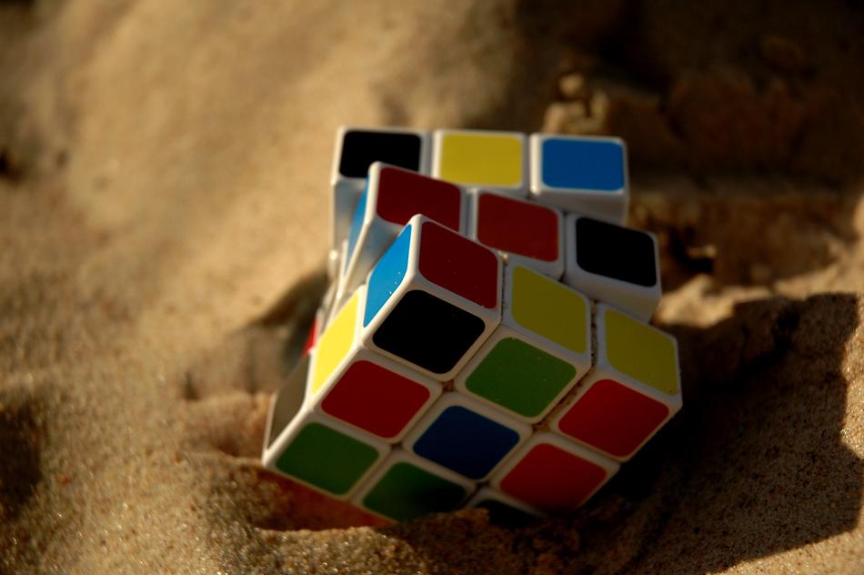 colored rubik cube in the sand
