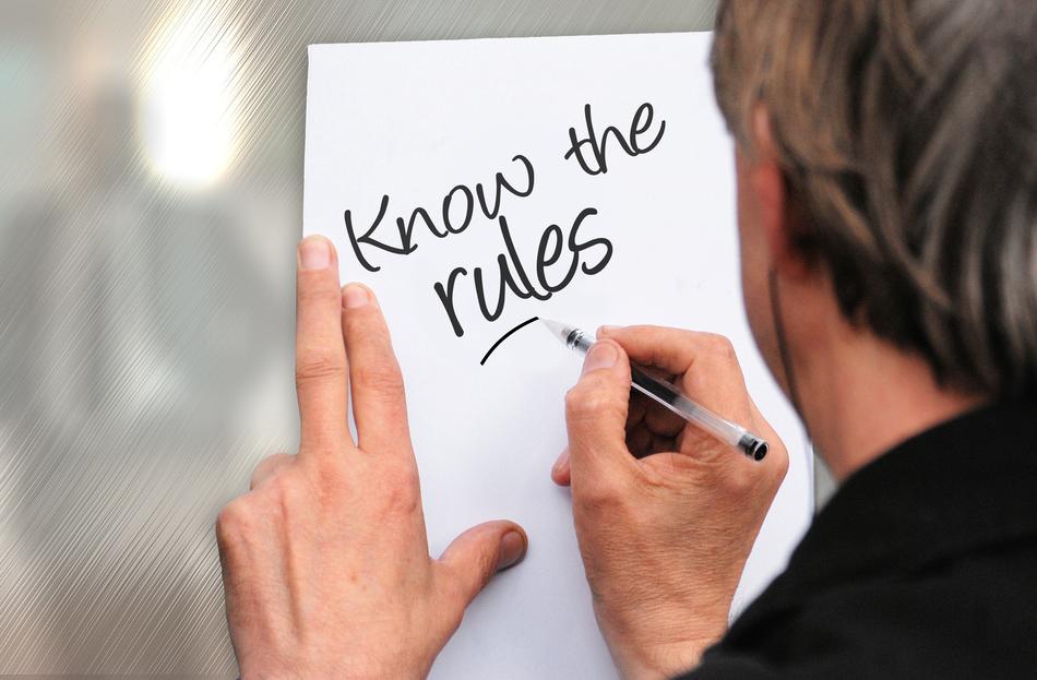 man writes on a sheet of paper