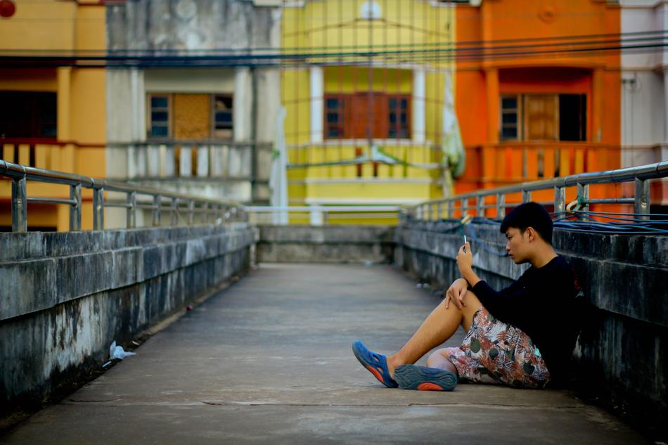 a lonely man on a bridge