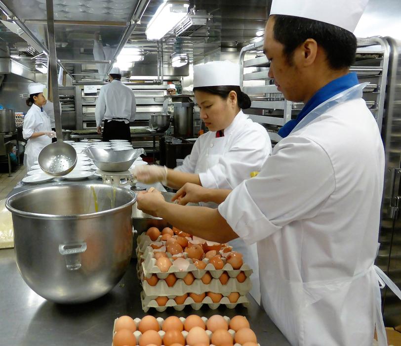 cooks prepare food in the kitchen