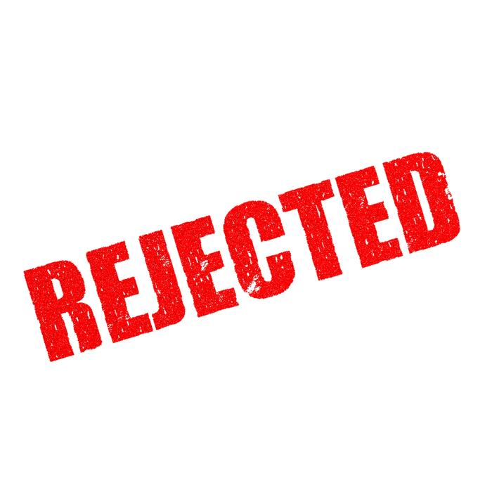 red rejection stamp on the paper
