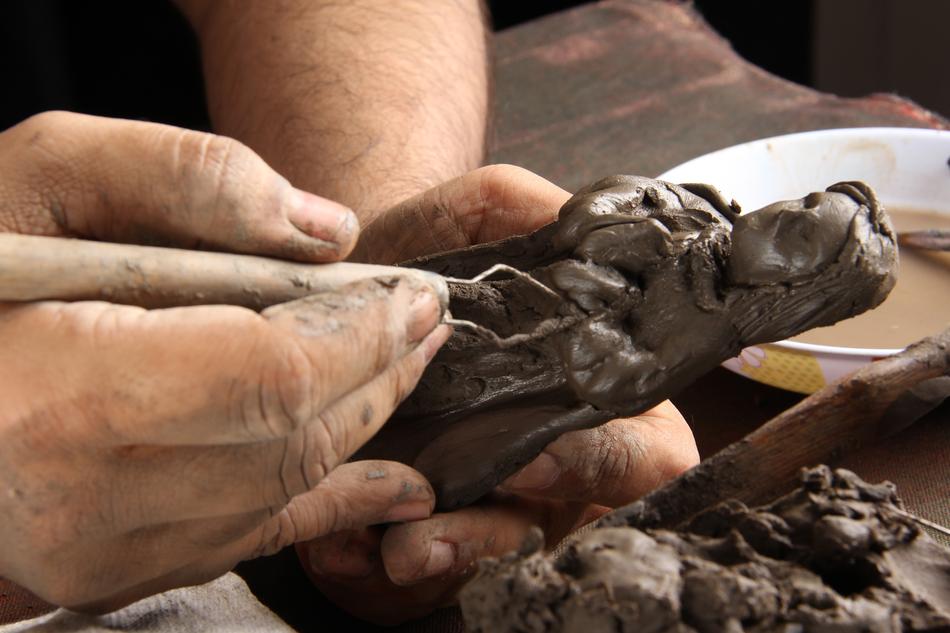 A man carves a Buddhist sculpture