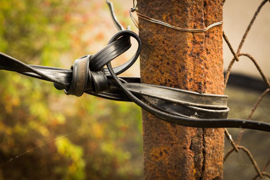 tied cord on a fence