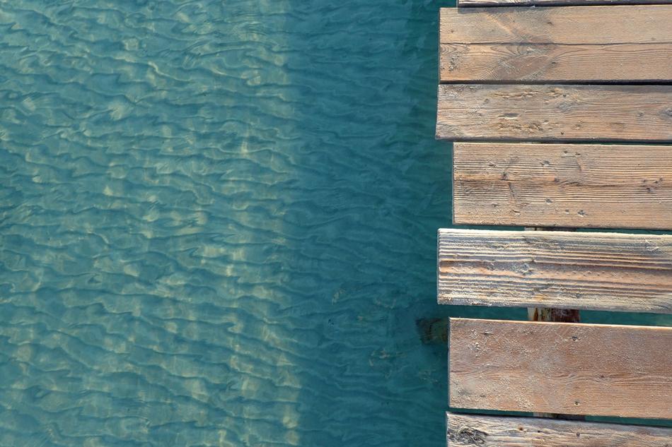 swimming pool with water and a wooden bridge