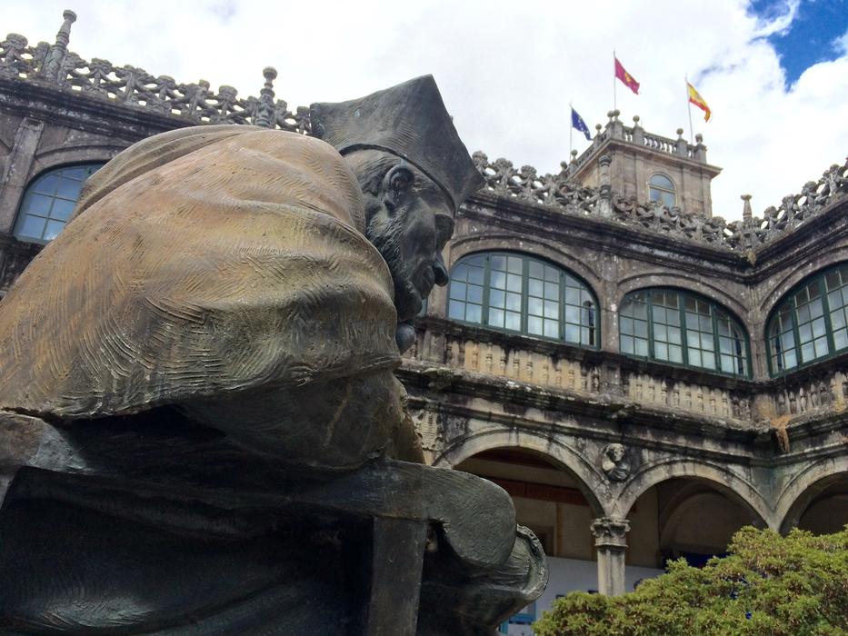 old man sculpture in front of the building