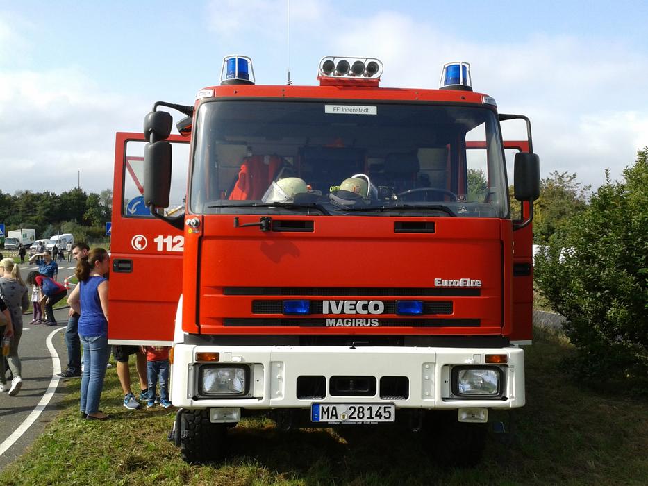 people near the red fire truck