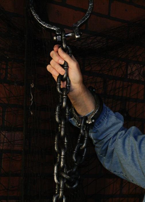 hand holds black chains