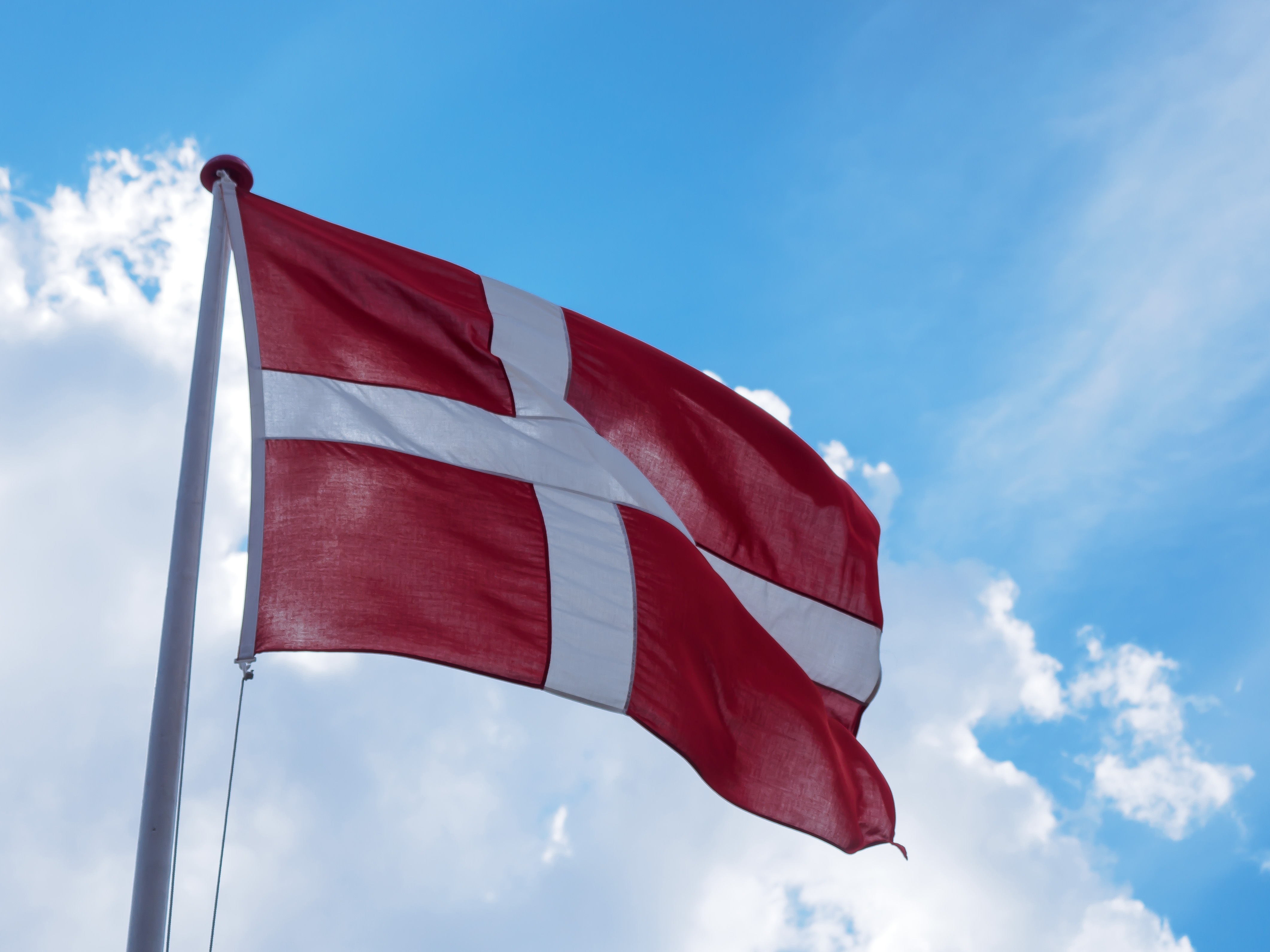 Danish Flag Flying In The Wind Against The Sky Free Image Download