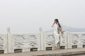 A girl in a white dress at the bridges