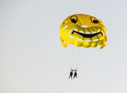 A happy couple on a yellow parachute