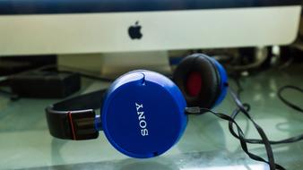 blue sony Headphones at apple monitor