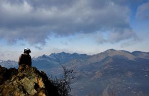 Guy on Mountain and cloudy Sky