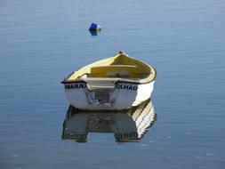 wooden boat sailing to a buoy