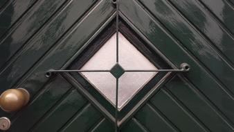 diamond shaped window on the door of the house