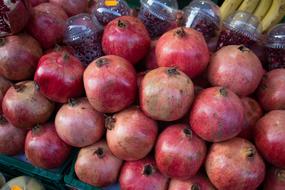 ripe pomegranates in a box at the market
