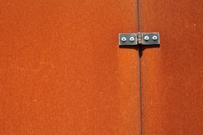 surface of two rusty metal sheets joined with rivets