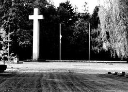 high cross in the cemetery in black and white background