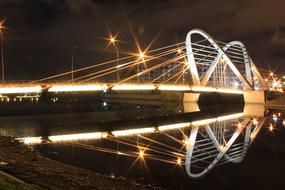 Beautiful Lazarev Bridge with colorful lights, at night in St Petersburg in Russia
