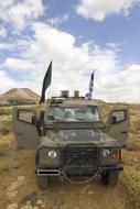 military vehicle with flags