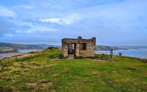 ruins on a cliff on the coast in cornwall