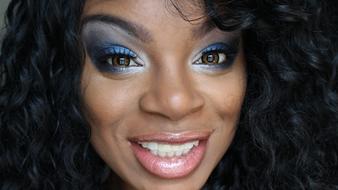 face of happy african woman with bright Makeup close up