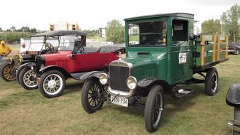green and red old cars at the exhibition